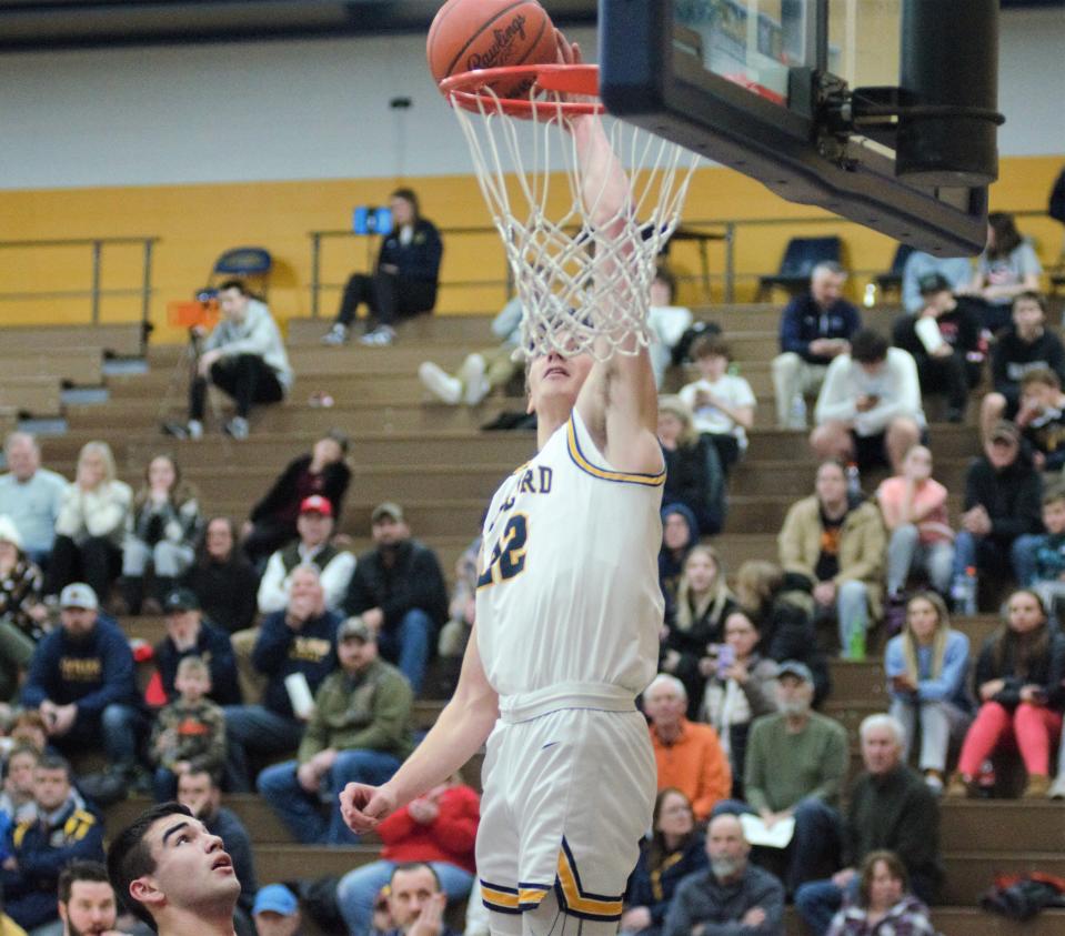 Luke Gelow catches an alley-oop pass above the rim during a boys basketball matchup between Gaylord and Sault Ste Marie on Tuesday, Jan. 9 in Gaylord, Mich.