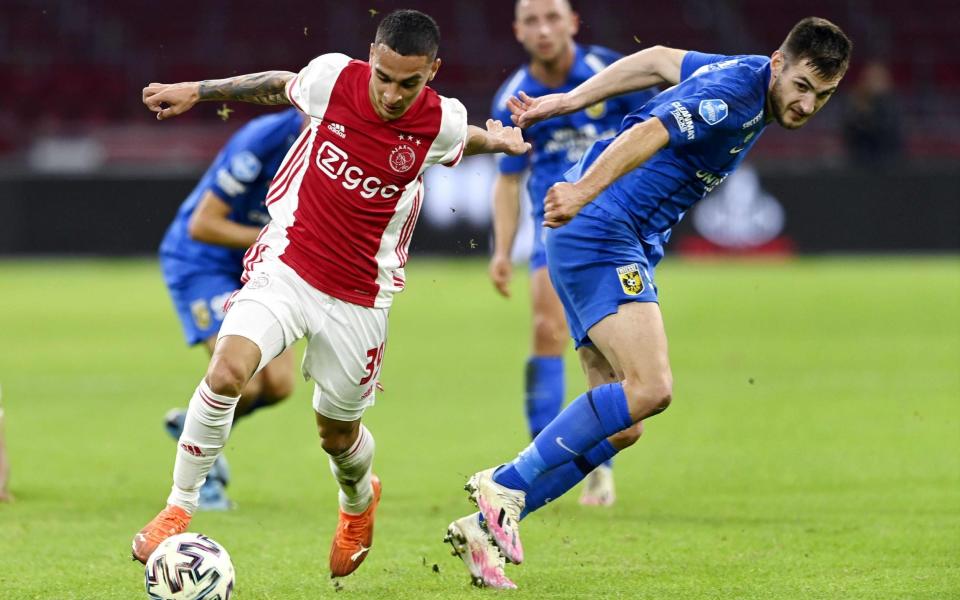 Ajax's Brazilian forward Antony (L) fights for the ball against Vitesse's Slovak midfielder Matus Bero during the Dutch Eredivisie - AFP