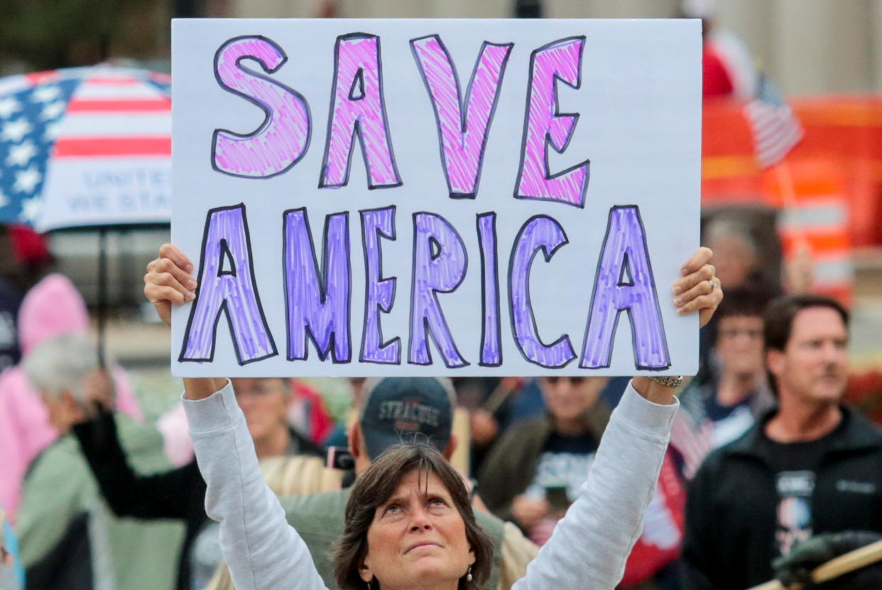 A supporter of former U.S. President Donald Trump holds a sign as others gather outside the Michigan State Capitol to demand an audit of 2020 election votes, in Lansing, Michigan, U.S. October 12, 2021. (Rebecca Cook/Reuters)