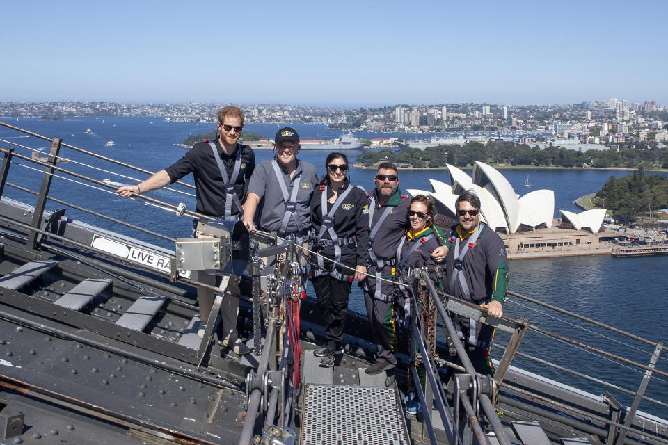 CAPTION CORRECTS THE DATE - Britain's Prince Harry, left, Australia's Prime Minister Scott Morrison, second from left, and Invictus Games representatives climb the Sydney Harbour Bridge in Sydney, Friday, Oct. 19, 2018. Prince Harry and his wife Meghan are on day four of their 16-day tour of Australia and the South Pacific. (AP Photo/Steve Christo, Pool)