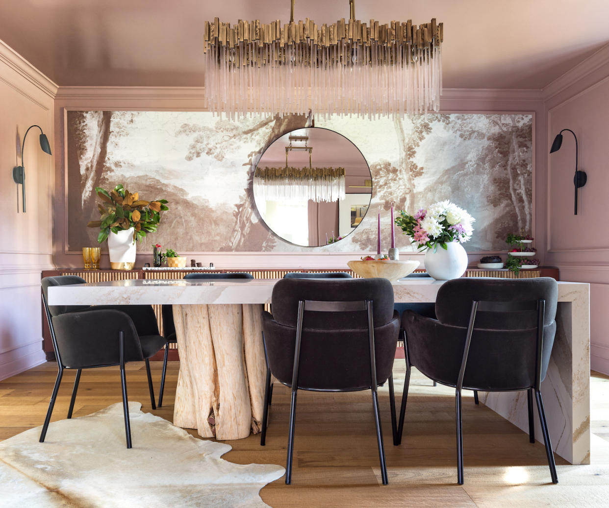  A pink dining room with a feature wall of wallpaper. 