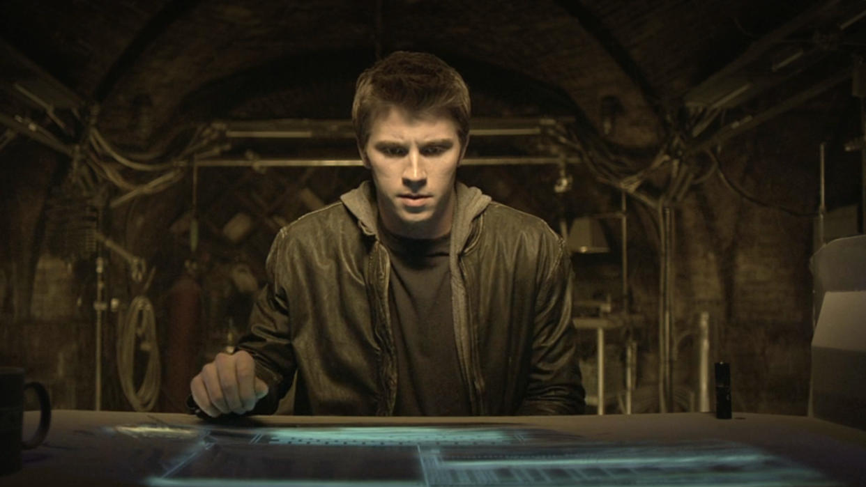  Garrett Hedlund sits in front of a futuristic looking computer in Tron: Legacy. 