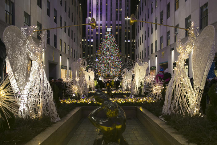<p>Angels hold up trumpets in the garden at Rockefeller Center. (Gordon Donovan/Yahoo News) </p>