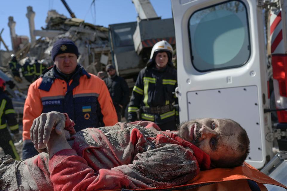 Rescuers carry a Ukrainian soldier saved after 30 hours from debris of the barracks hit by Russian rockets in Mykolaiv (AFP/Getty)