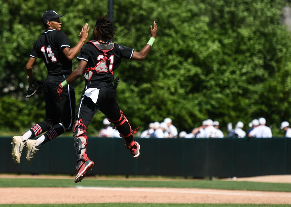 Detroit Edison's Kole Waterman, left, and Davion Williams celebrate Friday, June 17, 2022, after winning the MHSAA D3 semifinal 3-2 against Pewamo-Westphalia at McLane Stadium in East Lansing.