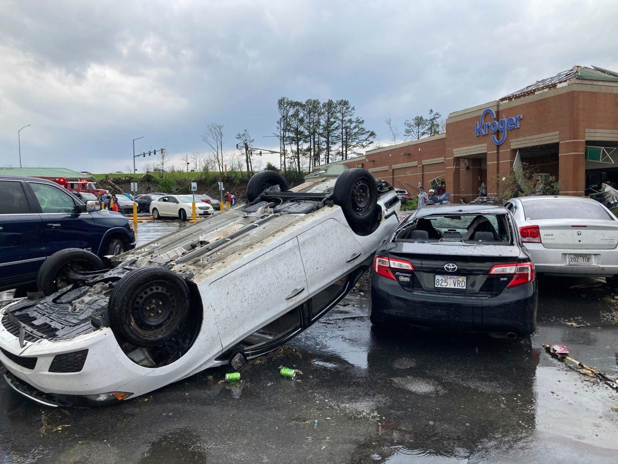 A car is upturned in a Kroger parking lot after a severe storm swept through Little Rock, Ark., Friday, March 31, 2023.