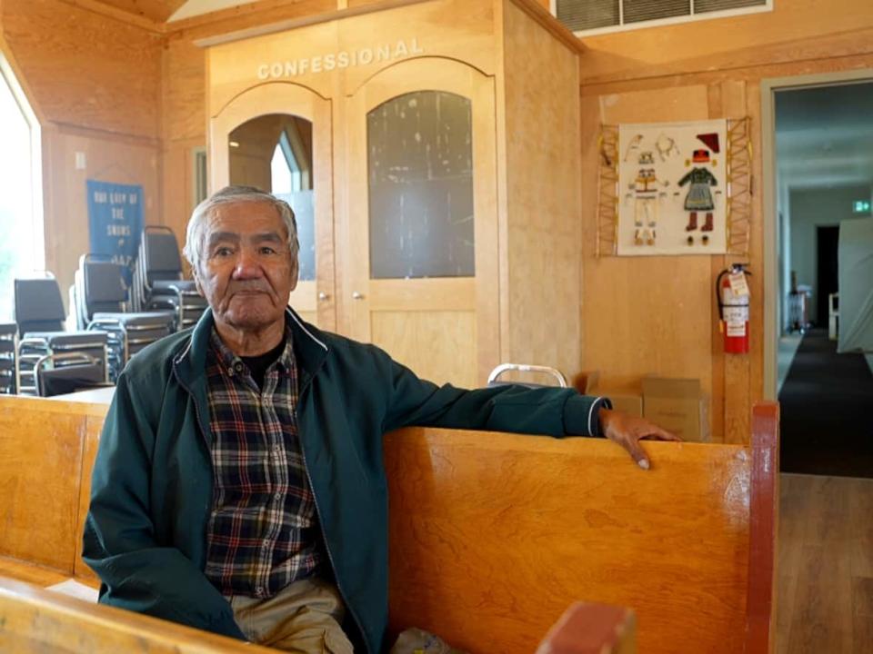 Penote Antuan, sitting here in his church on Sheshatshiu Innu First Nation, says he wants to see the Pope apologize for harms done by Catholic people. (Heidi Atter/CBC - image credit)