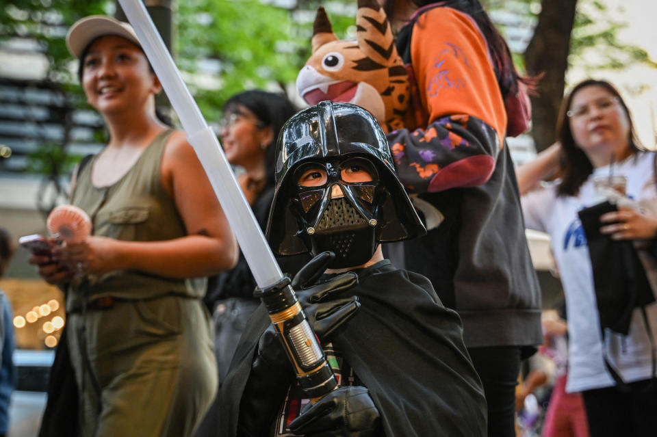 A child Star Wars fan wearing a Darth Vader costume in Manila on May 4.