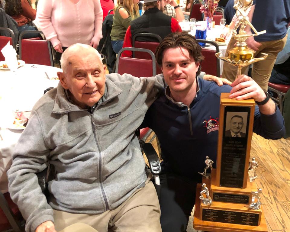 Peoria Rivermen defenseman Nick Neville visits with Rivermen Hall of Fame (builders inductee) Marc Olson, whose namesake team trophy Neville won for dedication to the game and community service at a team banquet in the Bullpen Sports Bar & Grill on Tuesday, March 28, 2023.
