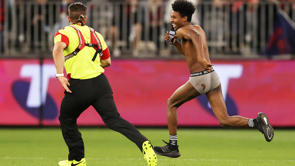 Abra Bol, pictured here running onto the field in his underwear during the AFL grand final. 