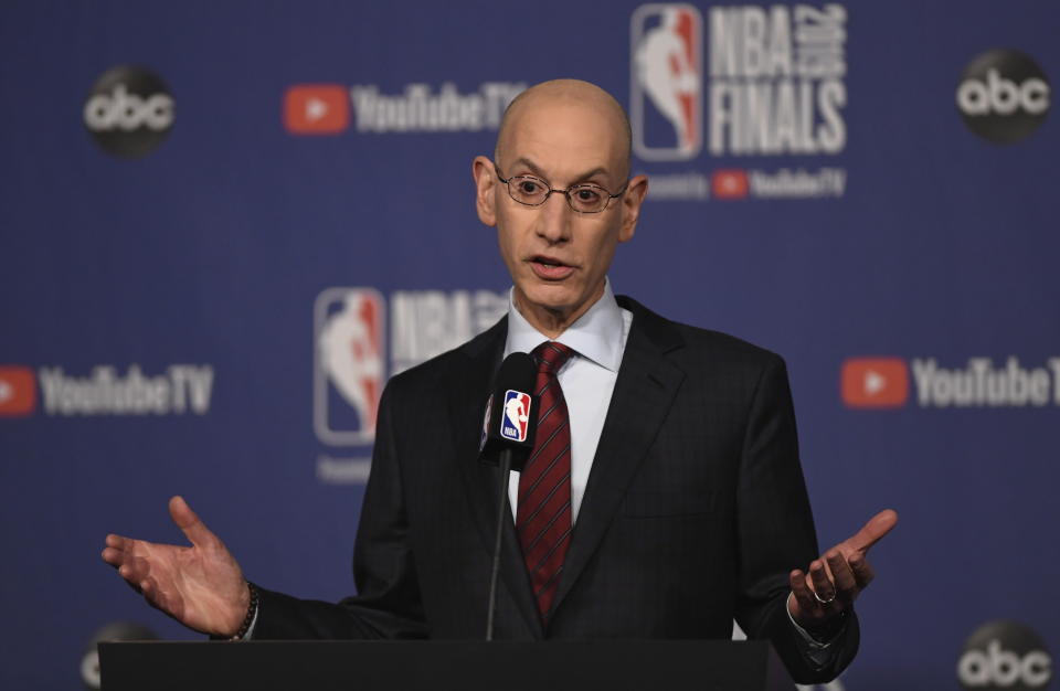 FILE - In this May 30, 2019, file photo, NBA Commissioner Adam Silver holds a news conference before Game 1 of basketball's NBA Finals between the Golden State Warriors and the Toronto Raptors in Toronto. The NBA's board of governors was unanimous Friday, Sept. 20, 2019, in its approval of a plan to stiffen potential penalties for tampering with players and employees under contract with other clubs, hoping for increased compliance in existing league rules. "We need to ensure that we're creating a culture of compliance in this league," Silver said after two days of meetings concluded in New York. (Frank Gunn/The Canadian Press via AP, File)