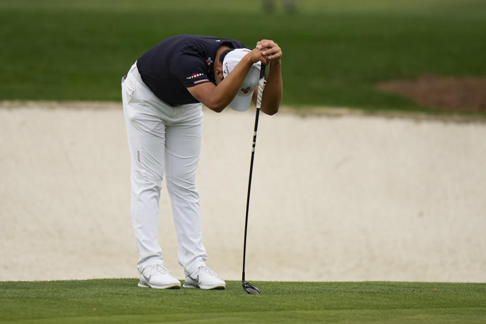 CORRECTS SPELLING OF NAME TO SI, NOT IS - Si Woo Kim, of South Korea, leans on his 3 wood which he had to use to putt on the 16th green during the second round of the Masters golf tournament on Friday, April 9, 2021, in Augusta, Ga. (AP Photo/Matt Slocum)