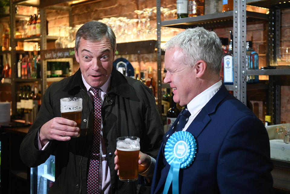 Brexit Party leader Nigel Farage and Peterborough candidate Mike Greene enjoy a pint in the Queen's Head pub during a walkabout in Peterborough, Cambridgeshire, while on the campaign trail ahead of the General Election.
