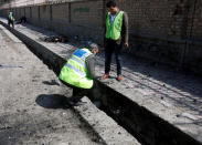 Afghan officials inspect the site of a suicide attack in Kabul, Afghanistan March 21, 2018. REUTERS/Omar Sobhani