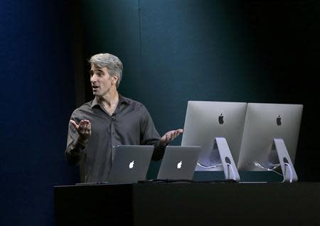 Craig Federighi, Apple Inc. Senior Vice President of software engineering, speaks on stage during an Apple event in San Francisco, California October 22, 2013. REUTERS/Robert Galbraith