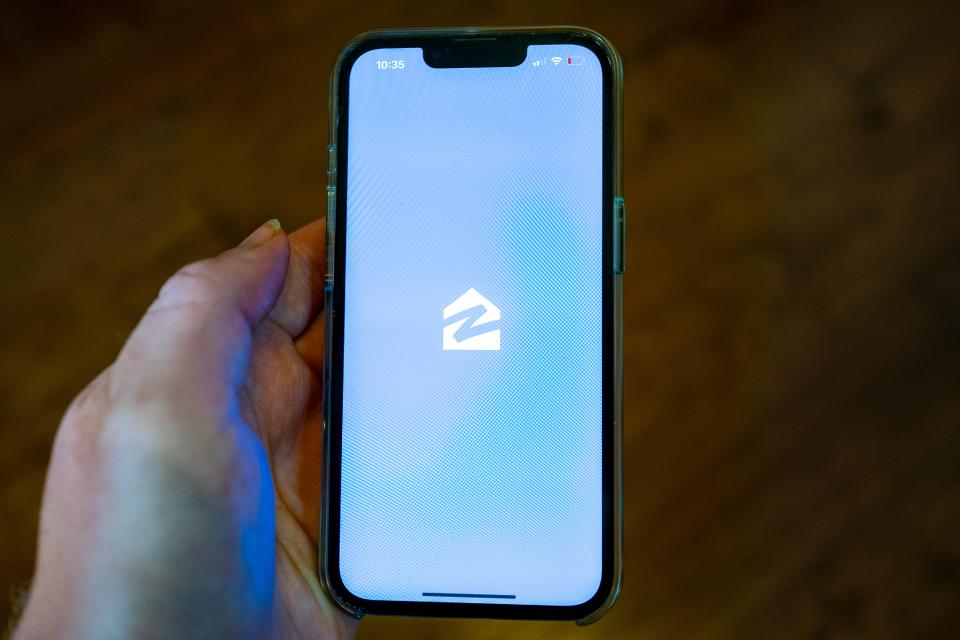 Person's hand holding an iPhone and using the Zillow app, Lafayette, California, July 12, 2024. (Photo by Smith Collection/Gado/Getty Images)