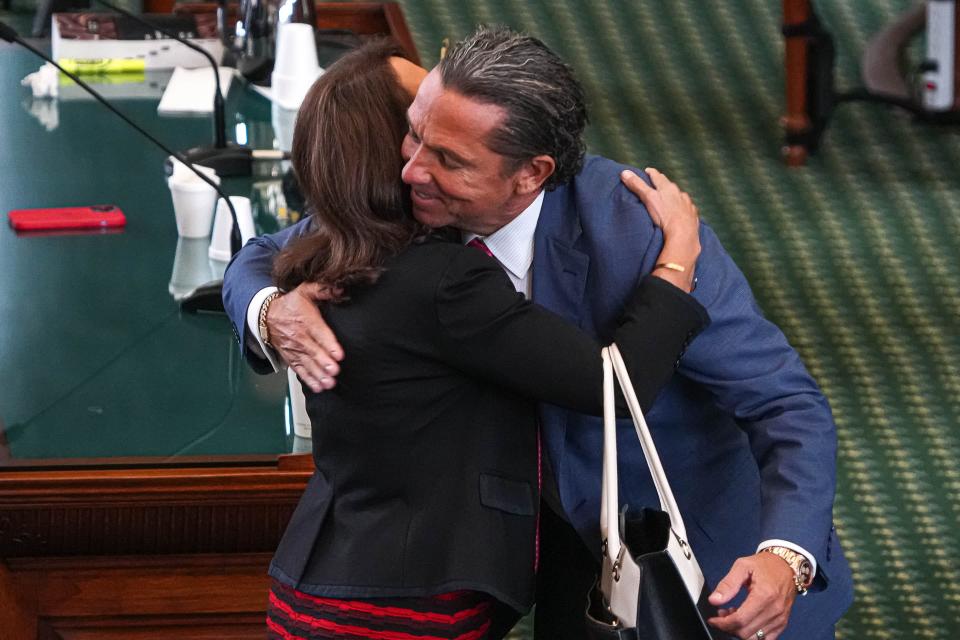 Sen. Angela Paxton hugs Tony Buzbee, attorney for her husband, Attorney General Ken Paxton, after the acquittal Saturday.