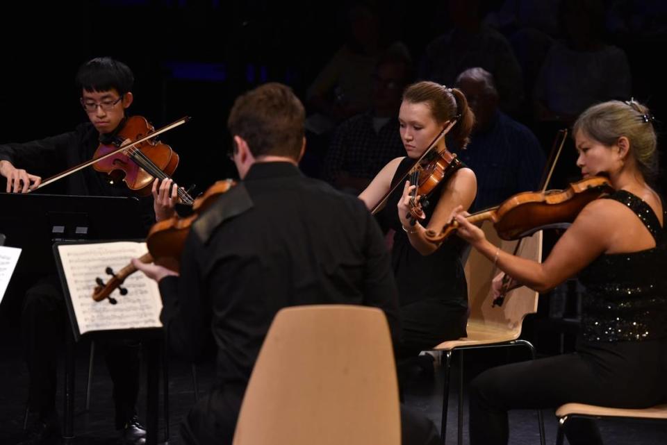 Jeffrey Shen, Nathan Cole (back to camera), Madeline Farrar and Akiko Tarumoto play as part of Mendelssohn’s “Octet” at the first main stage concert of the 2018 Chamber Music Festival of Lexington at the Pam Miller Downtown Arts Center in Lexington.