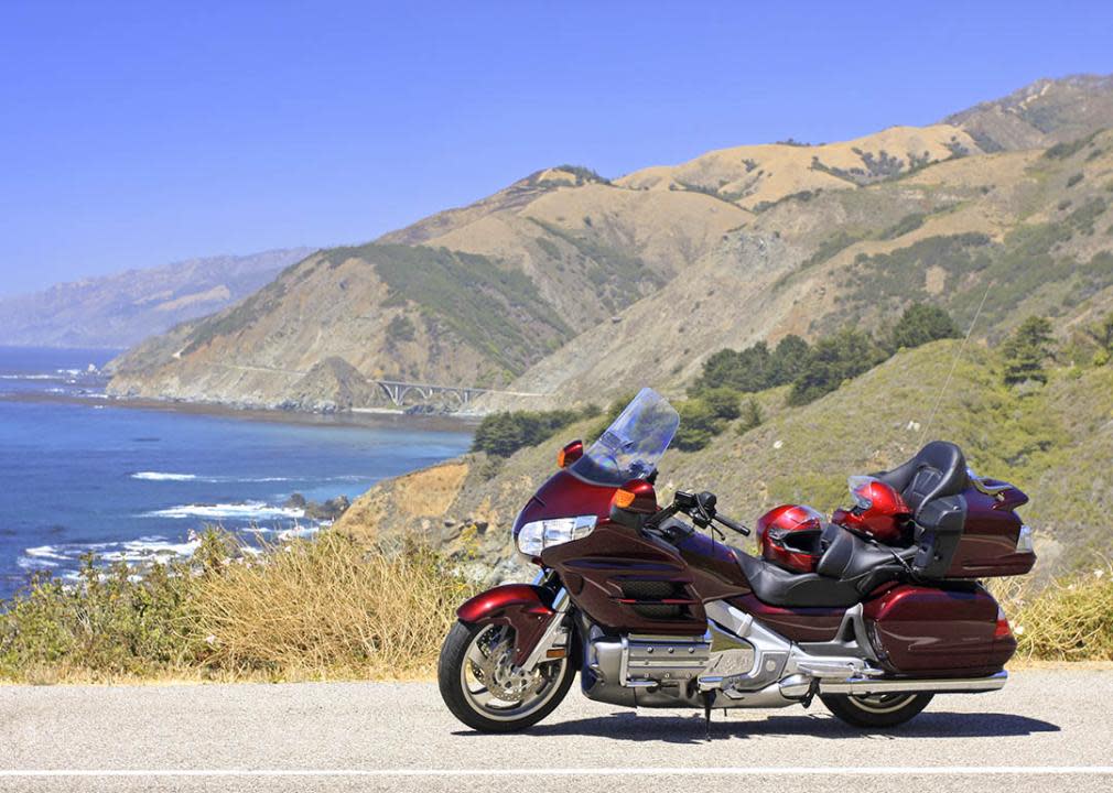 motorcycle parked next to the ocean in Big Sur