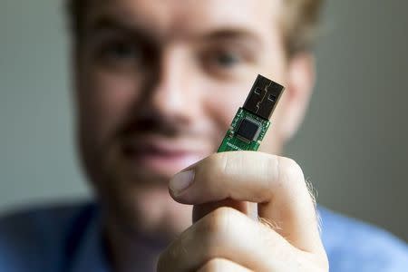 German crypto specialist and chief scientist with Berlin's SR Labs Karsten Nohl poses with a USB stick at his office in Berlin, July 30, 2014. REUTERS/Thomas Peter