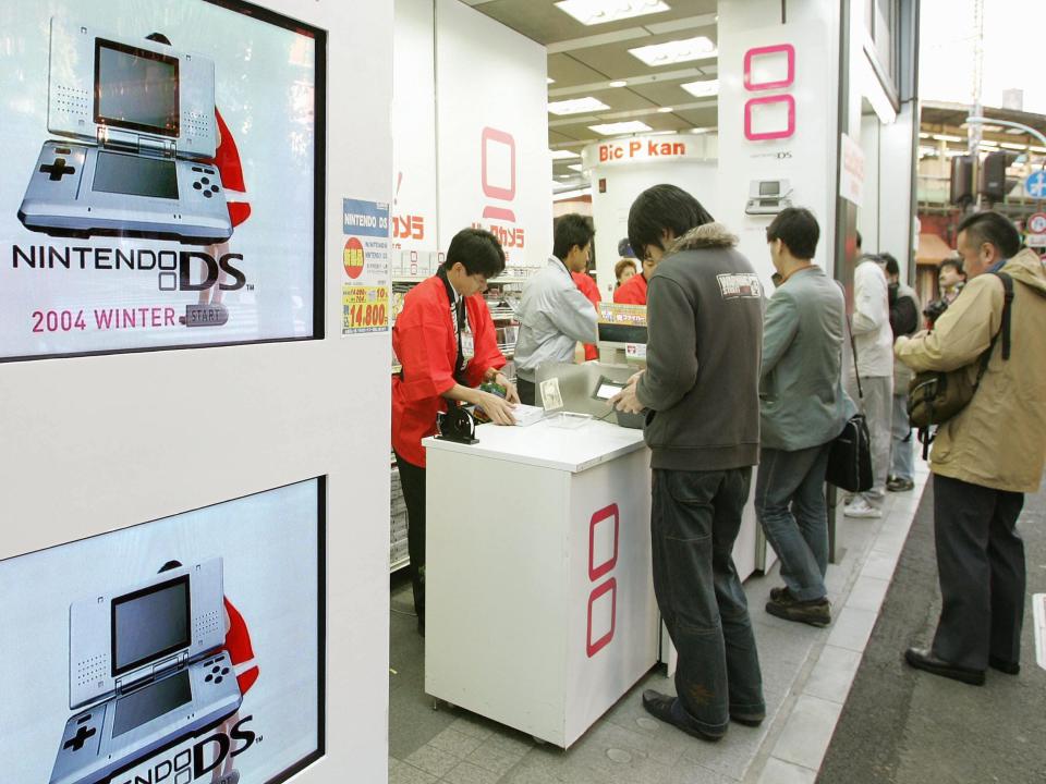 Customers gather in Tokyo to purchase the new Nintendo DS in 2004.