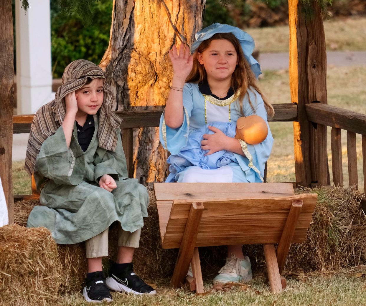 Students Will VanSant-Knight, dressed as Joseph, and Leigh Huchton, dressed as Mary, take part in an outdoor live Nativity scene and react to people in the carpool line at Casady School, 9500 N Pennsylvania.