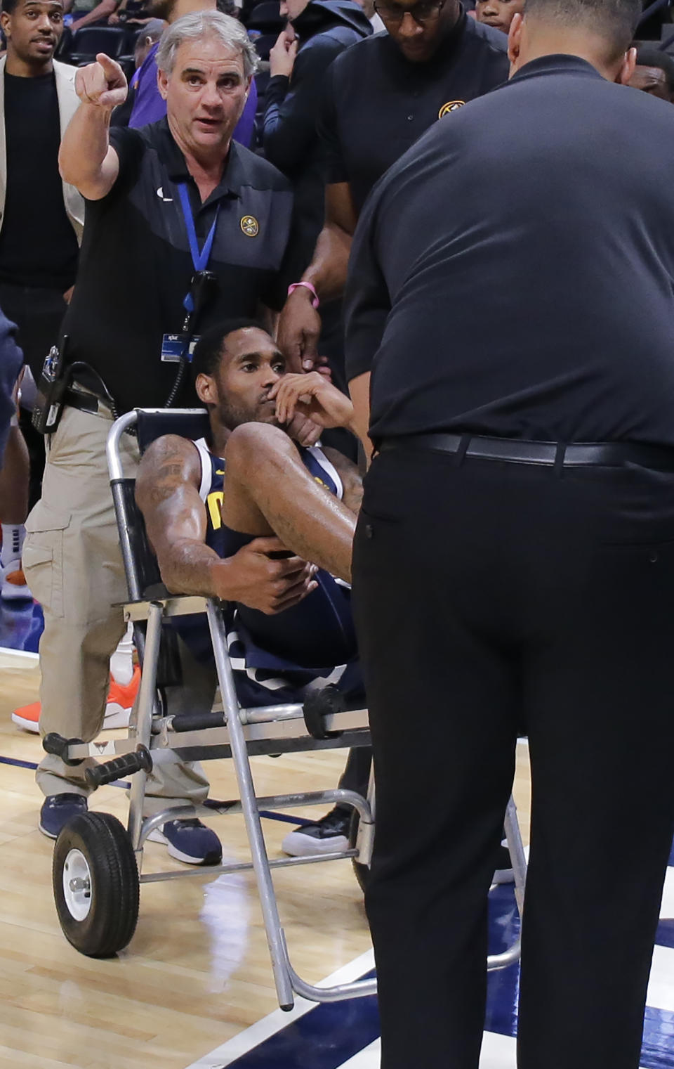 Denver Nuggets guard Will Barton is carted off the court after being injured during the third quarter of an NBA basketball game against the Phoenix Suns, Saturday, Oct. 20, 2018, in Denver. (AP Photo/Jack Dempsey)