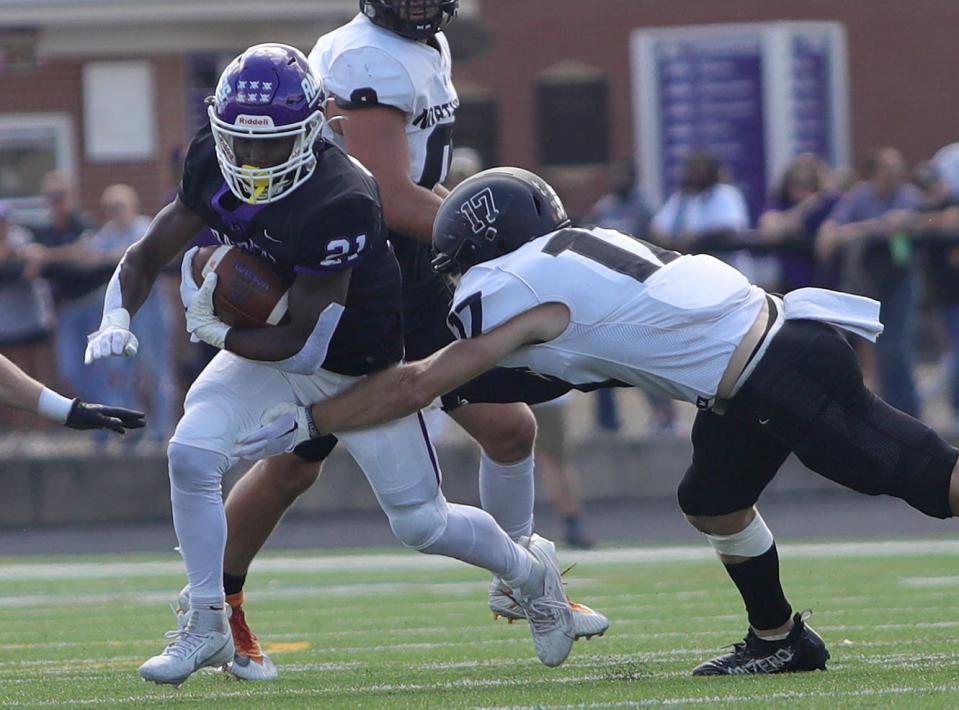 Mount Union's Darnell Williams (left) tries to avoid a tackle from Ohio Northern's Dalton Tjong during a game last month.