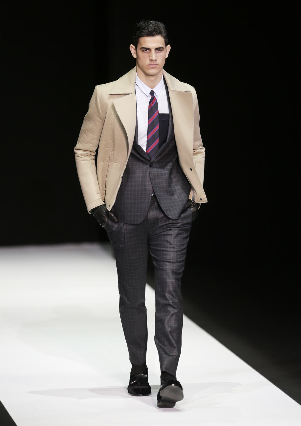 A model wears a creation for Emporio Armani men's Fall-Winter 2013-14 collection, part of the Milan Fashion Week, unveiled in Milan, Italy, Monday, Jan. 14, 2013. (AP Photo/Antonio Calanni)