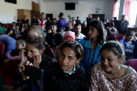 Young people attend the forum theatre play "Cristina's Story", directed by Romanian-Roma actress Mihaela Dragan and organised by feminist Roma NGO E-Romnja, in Valea Seaca, Romania, April 16, 2016. The play, in which people from the community also act, addresses issues related to domestic violence, poverty, racism and the challenges of living and working in Western Europe. REUTERS/Andreea Campeanu