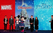 Hong Kong Disneyland Resort Executive Vice President and Managing Director Samuel Lau (2nd L) and Hong Kong Secretary for Commerce and Economic Development Gregory So (3rd R) pose with Mickey Mouse and Minnie Mouse characters during a presentation on Hong Kong Disneyland's resort expansion and development plan in Hong Kong, China November 22, 2016. REUTERS/Bobby Yip