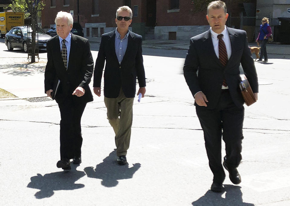 William Stenger, left, former president of Jay Peak resort, approaches federal court on Wednesday, May 22, 2019, in Burlington, Vt., to face fraud charges over a failed plan to build a biotechnology plant using foreign investors' money. He pleaded not guilty. (AP Photo/Lisa Rathke)
