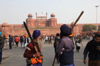 NEW DELHI, INDIA - JANUARY 26: Indian farmers gather at the iconic Red Fort during Republic Day to protest over new farming laws on January 26, 2021 in in New Delhi, India. Some farmers stormed the Red Fort and hoisted flags from the ramparts where traditionally India’s Prime Minister hoists the national flag on Independence Day. (Photo by Pallava Bagla/Corbis via Getty Images)