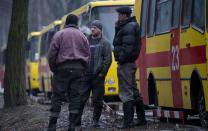 Rescuers take a break near their vehicles in Donetsk on March 4, 2015, after a blast in the Zasyadko coal mine