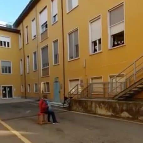 Mr Bozzini played in the courtyard beneath his wife's hospital ward in northern Italy - Facebook