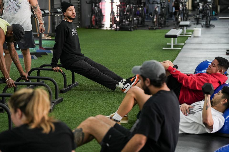 Tony Ramos instructs a group of creatives as he coaches at East Austin Athletic Club Thursday, Feb. 9, 2023. Ramos is the co-owner of East Austin Athletic Club, a full-service gym where he has built a community of Austin creatives who attend exercise classes to support each other’s creative endeavors as much as they go for the workout. 