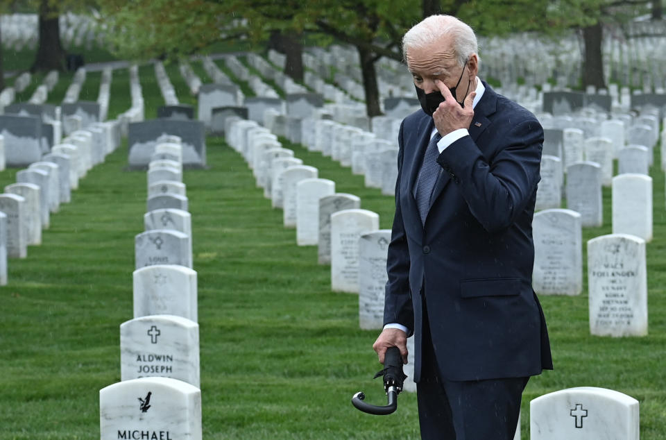 President Joe Biden wipes his eye as he walks through Arlington National Cemetery in Virginia on Wednesday.  (Photo: BRENDAN SMIALOWSKI via Getty Images)