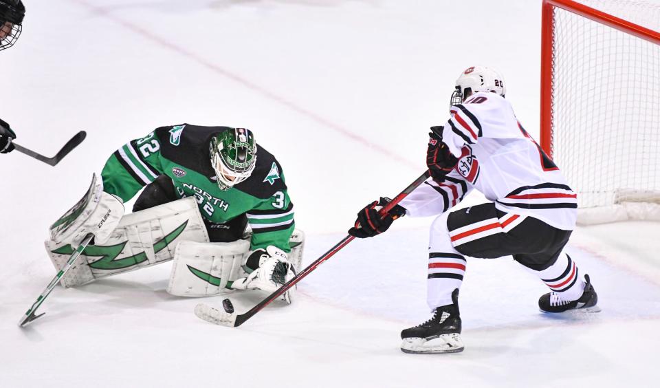 St. Cloud State's Nolan Walker takes a shot on North Dakota goaltender Jakob Hellsten during the first period of the game Friday, Dec. 3, 2021, at the Herb Brooks National Hockey Center in St. Cloud.