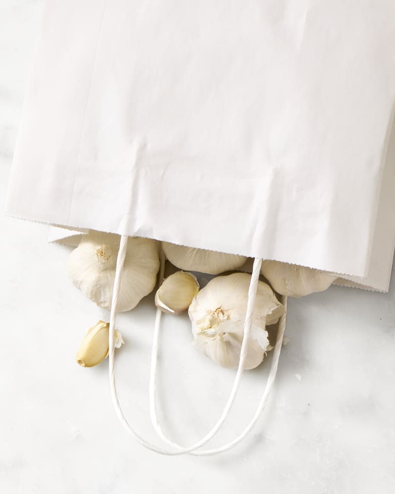 garlic tumbling out of a paper bag