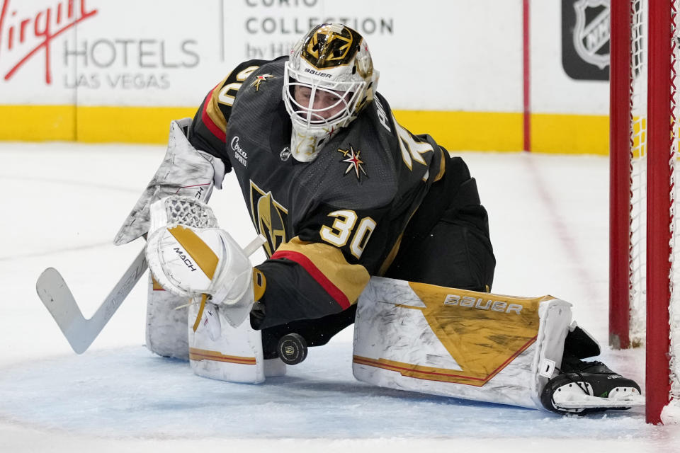 Vegas Golden Knights goaltender Jiri Patera (30) attempts a save against the Columbus Blue Jackets during the first period of an NHL hockey game Sunday, March 19, 2023, in Las Vegas. (AP Photo/John Locher)