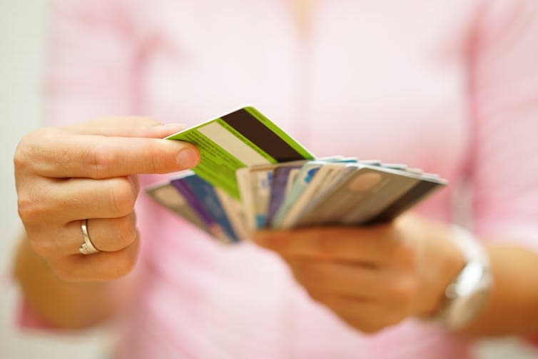 Woman choosing between different credit cards.