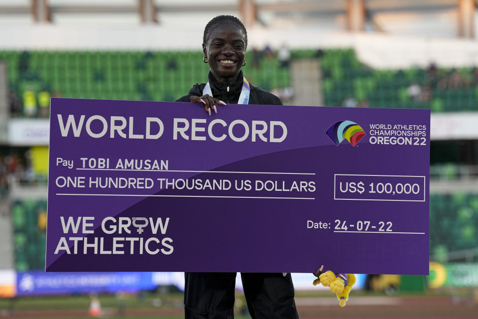 Gold medalist Tobi Amusan, of Nigeria, poses during a medal ceremony for the women's 100-meter hurdles at the World Athletics Championships on Sunday, July 24, 2022, in Eugene, Ore. (AP Photo/Gregory Bull)