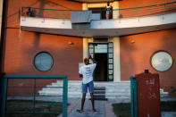 Congolese basketball player Christ Wamba throws his keys in the air as he chats with another tenant of an apartment building, provided under the UNHCR's ESTIA housing programme in Thessaloniki, Greece, September 13, 2018. REUTERS/Alkis Konstantinidis