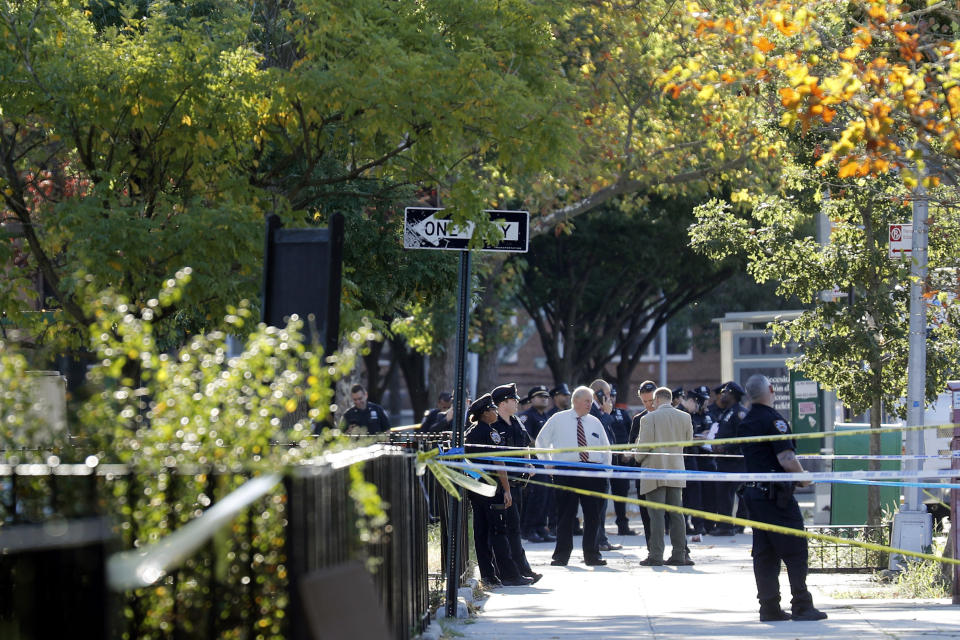 Emergency personnel work near the scene of a fatal shooting of a police officer in the Bronx borough of New York, Sunday, Sept. 29, 2019. (AP Photo/Seth Wenig)