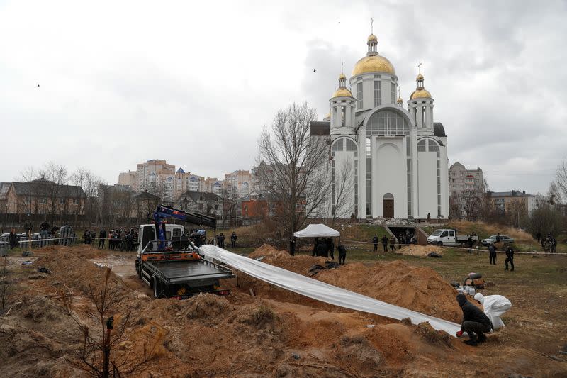 FILE PHOTO: Exhumation of bodies of civilians from a mass grave in Bucha