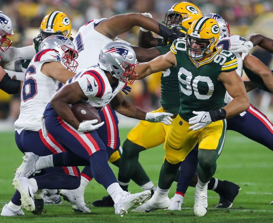 Green Bay Packers linebacker <a class="link " href="https://sports.yahoo.com/nfl/players/40037" data-i13n="sec:content-canvas;subsec:anchor_text;elm:context_link" data-ylk="slk:Lukas Van Ness;sec:content-canvas;subsec:anchor_text;elm:context_link;itc:0">Lukas Van Ness</a> (90) tackles New England Patriots running back <a class="link " href="https://sports.yahoo.com/nfl/players/34139" data-i13n="sec:content-canvas;subsec:anchor_text;elm:context_link" data-ylk="slk:Kevin Harris;sec:content-canvas;subsec:anchor_text;elm:context_link;itc:0">Kevin Harris</a> (36) during their preseason football game Saturday, August 19, 2023, at Lambeau Field in Green Bay, Wis. Tork Mason/USA TODAY NETWORK-Wisconsin