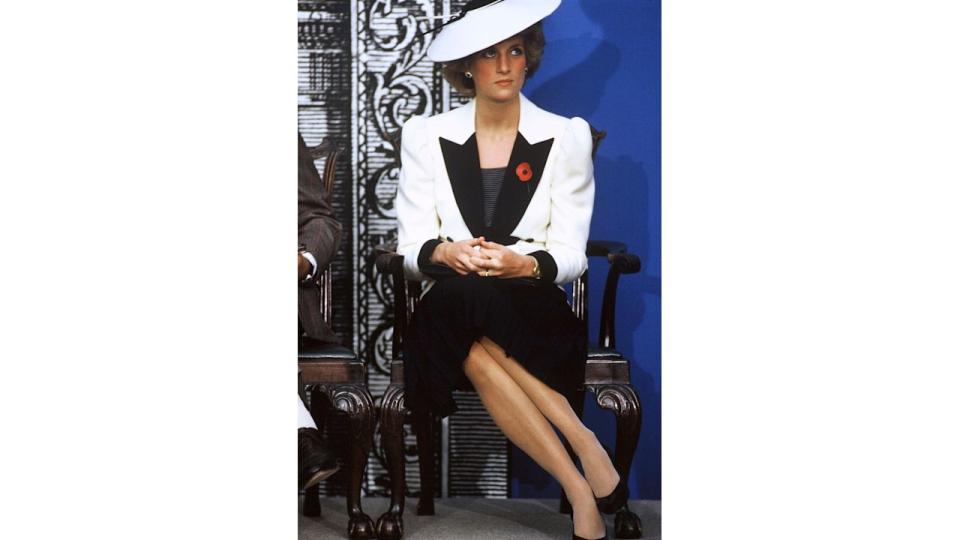 Princess Diana sat in black and white outfit with hat