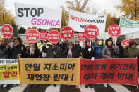 Protesters stage a rally to oppose a visit by U.S. Secretary for Defense Mark Esper in front of the Defense Ministry in Seoul, South Korea, Friday, Nov. 15, 2019. The sign reads "We demand to abolish the General Security of Military Information Agreement, or GSOMIA, an intelligence-sharing agreement between South Korea and Japan." (AP Photo/Ahn Young-joon)