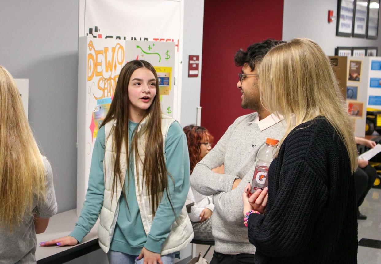 Salina Central High School sophomore Kylie Vonlintel (middle) presents her business idea "The Coffee Connection" during the tradeshow portion of the Youth Entrepreneurship Challenge March 1.