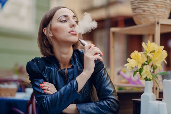 Woman using a personal vaping device